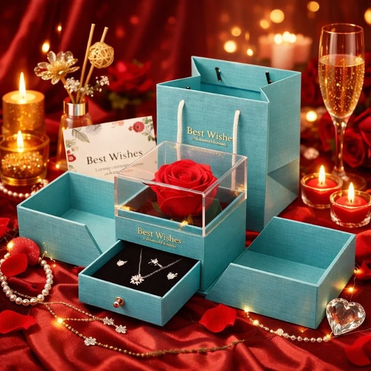 Teal blue luxury gift box from Kouvr with a preserved red rose under a clear display and a drawer containing a matching necklace and earrings for a special occasion.
