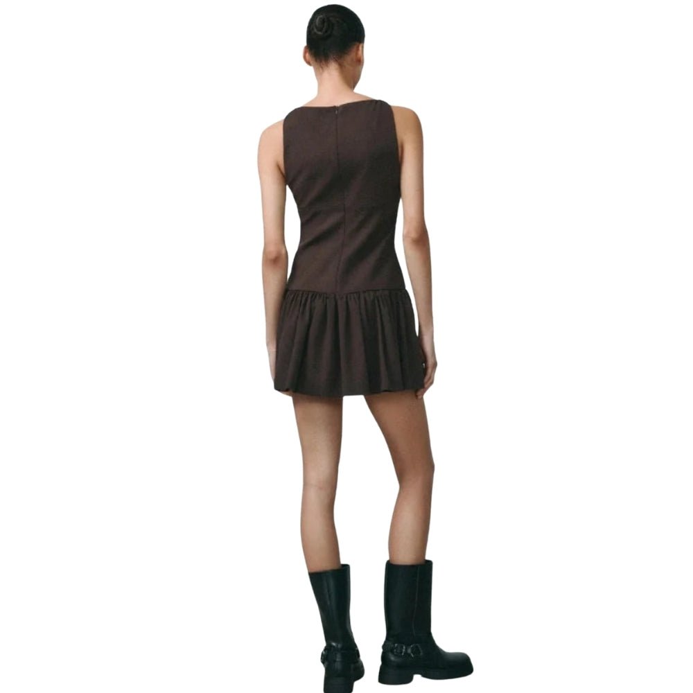 Person wearing a Brown Kouvr dress with black boots on a white background