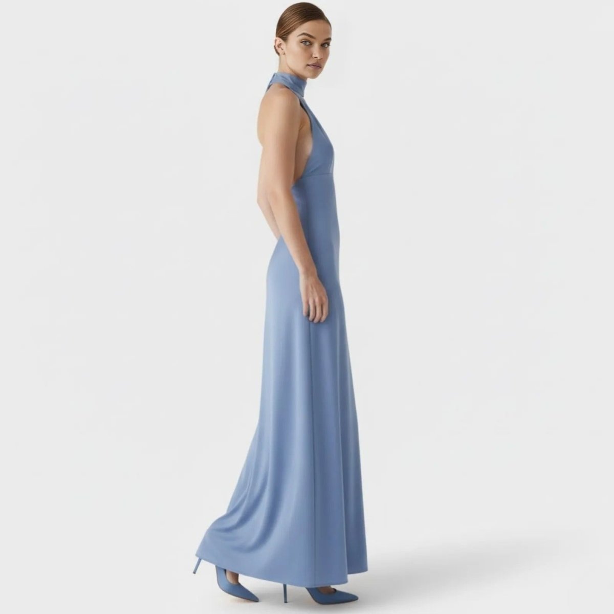 Side profile of a model in the Kouvr Sharon blue formal dress, highlighting the slim fit silhouette and floor-length design.