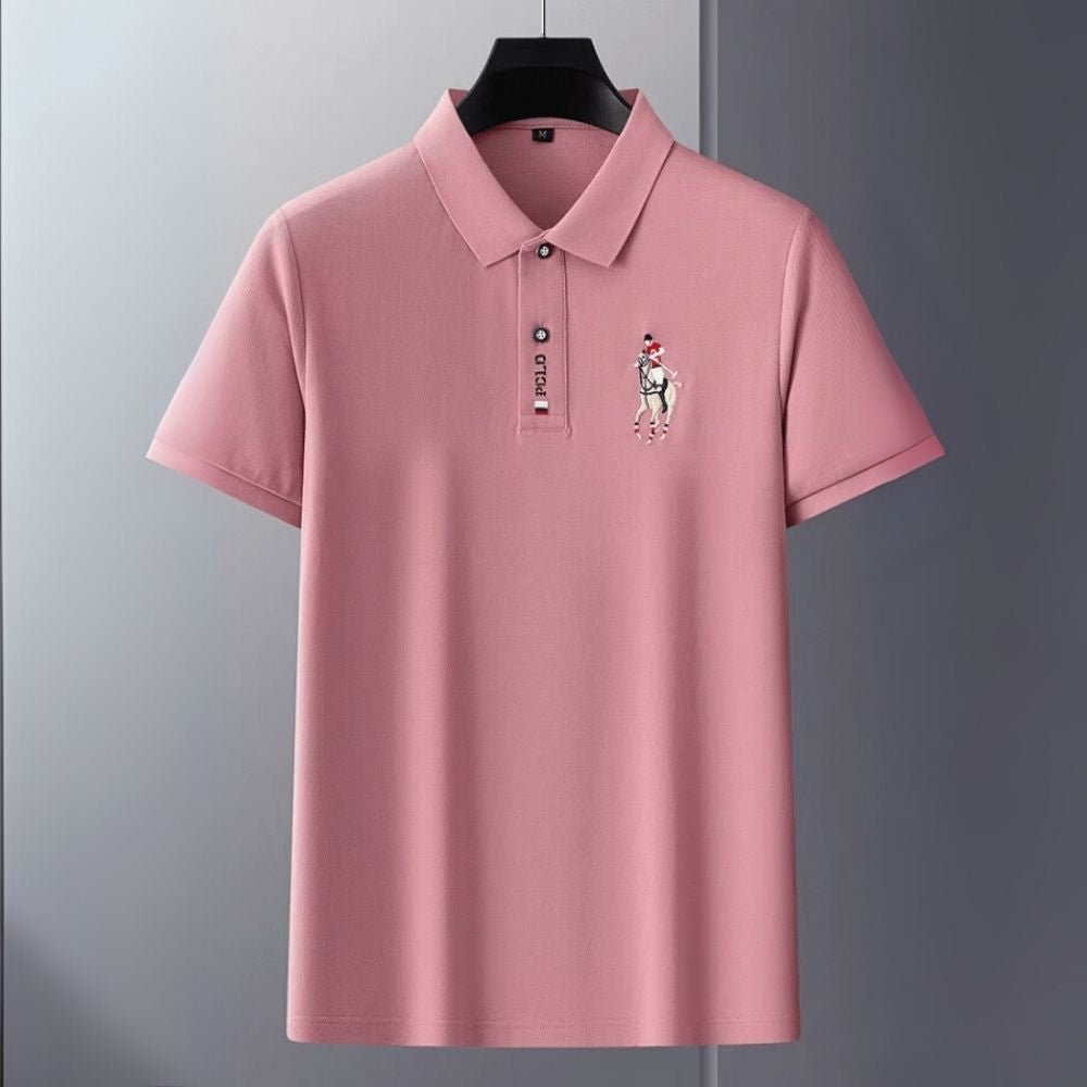 Pink kouvr polo shirt with a logo on a gray background