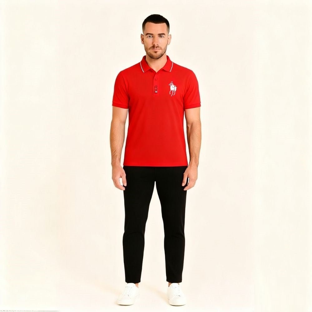 Man wearing a red kouvr polo shirt with a logo on a beige background
