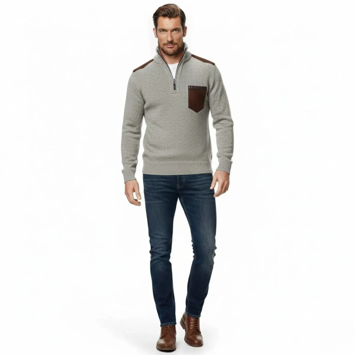 Male model wearing the Kouvr Soren half-zip sweater in heather beige with brown suede patches, paired with dark denim jeans, facing forward.