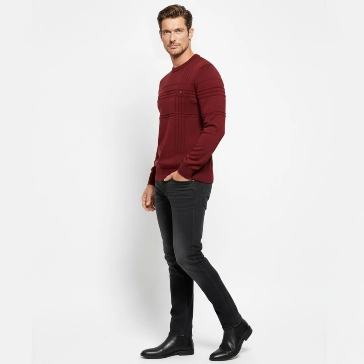 Male model in a side profile wearing the Kouvr red textured crewneck sweater, showcasing the ribbed sleeve detail.