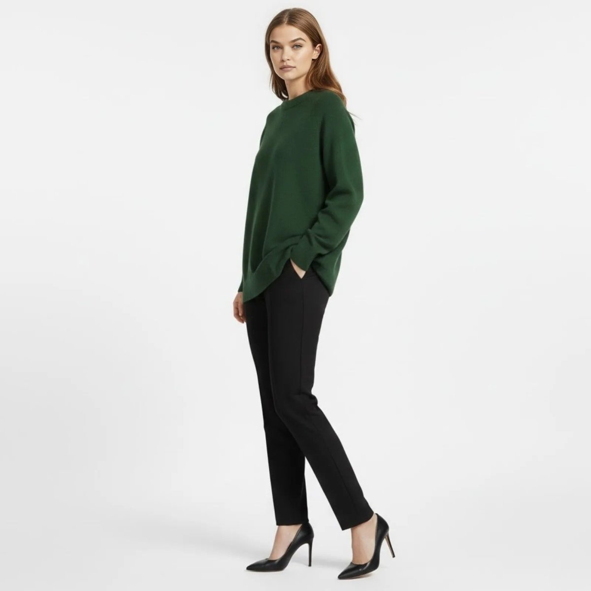 Side profile view of the Tina Oversized Sweater in forest green showing its relaxed fit and cocoon silhouette.