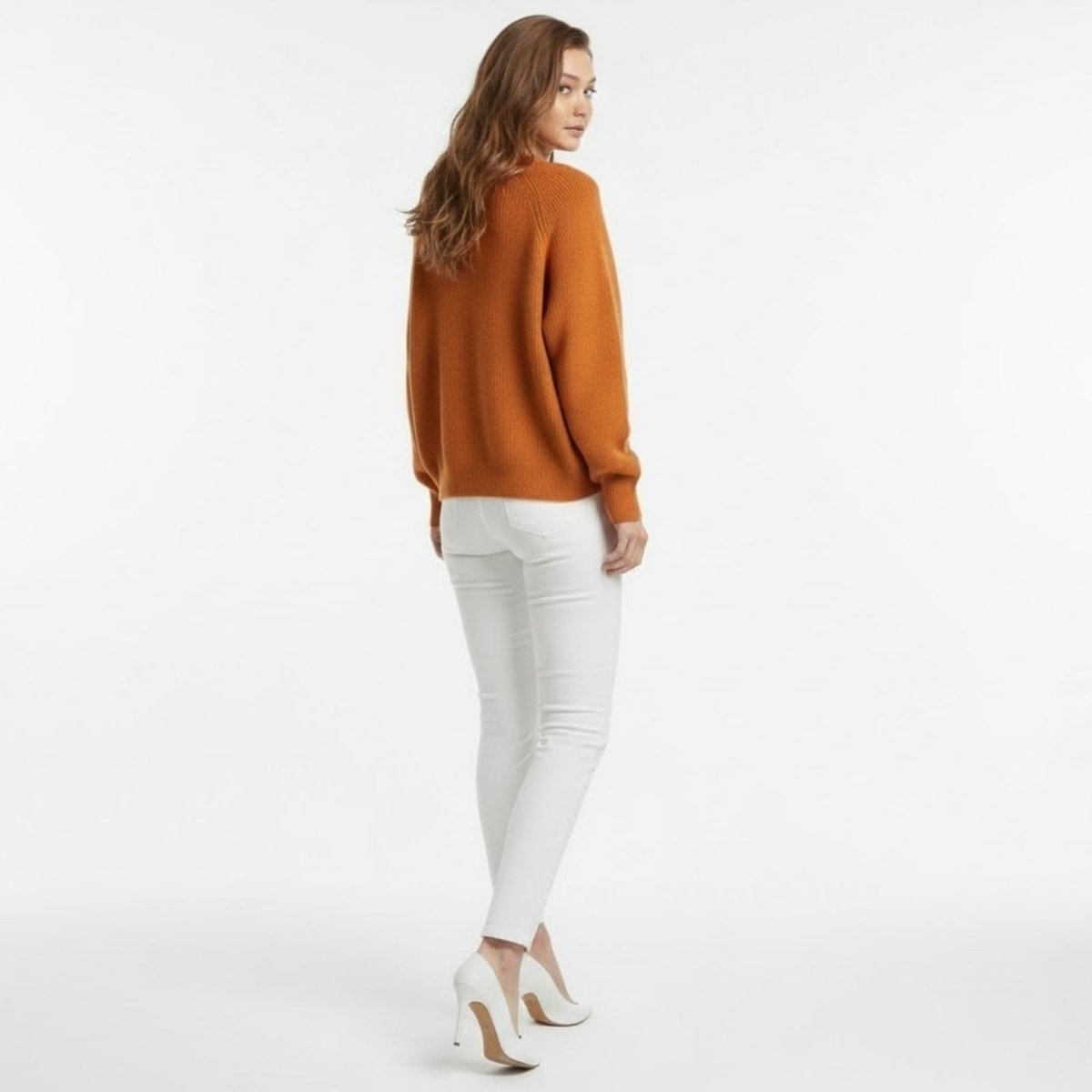 Back view of the Kouvr Tina oversized crewneck pullover, highlighting the sweater's elegant drape and rich terracotta color.