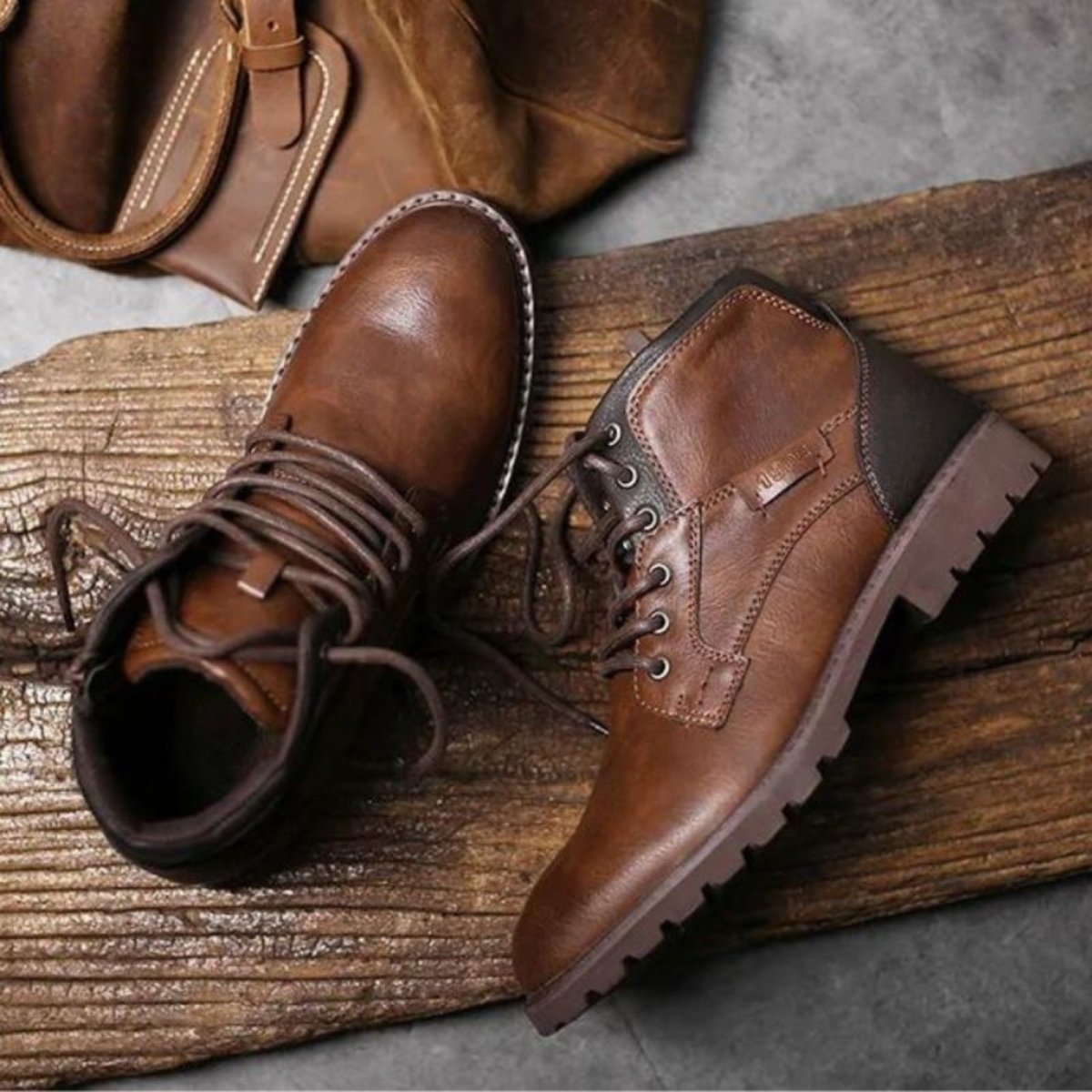 Brown leather boots on a wooden surface