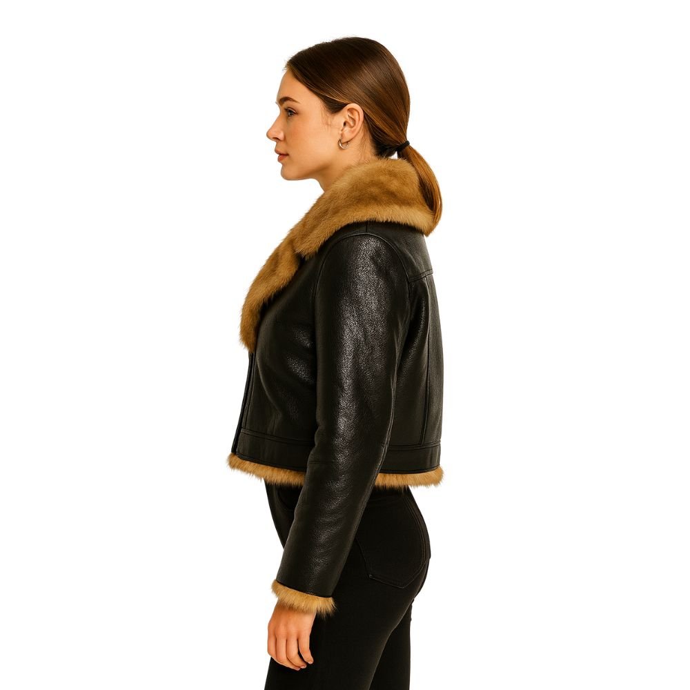 Woman wearing Kouvr Fashion black cropped faux leather aella jacket with brown faux shearling fur collar