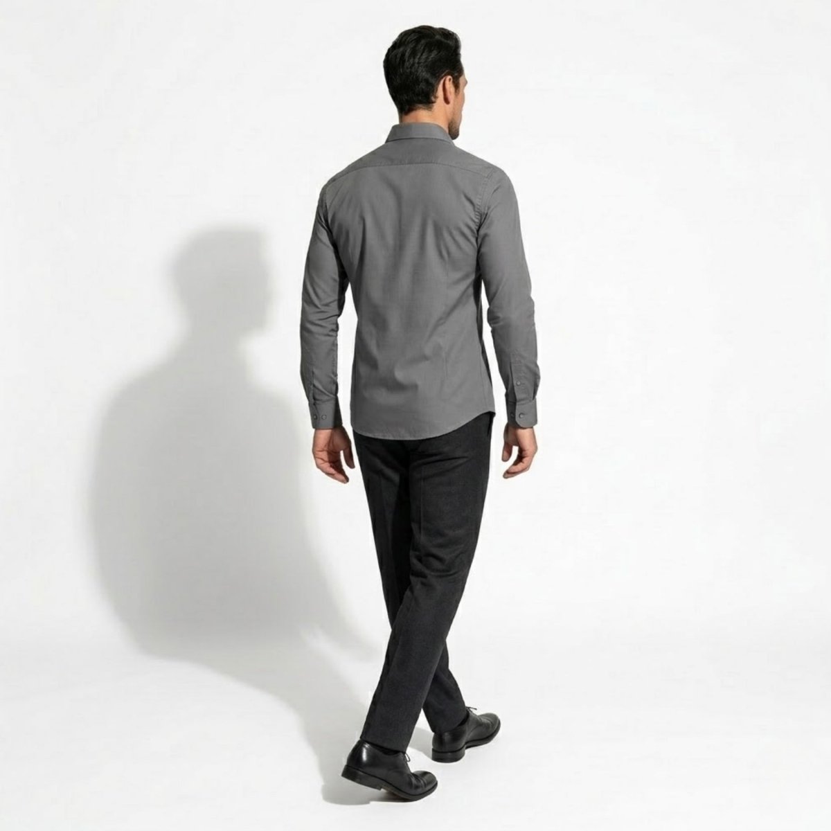 Back view of man modeling Kouvr fitted grey dress shirt showcasing shoulder yoke and back fit