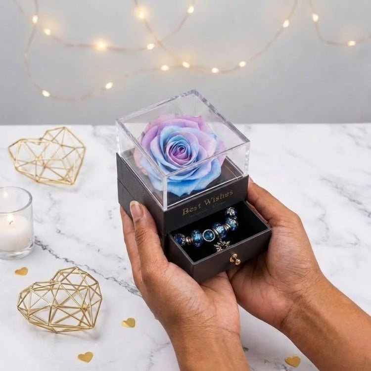 Person holding a galaxy-themed blue and purple ombre eternal rose box, showcasing the clear top and jewelry drawer.