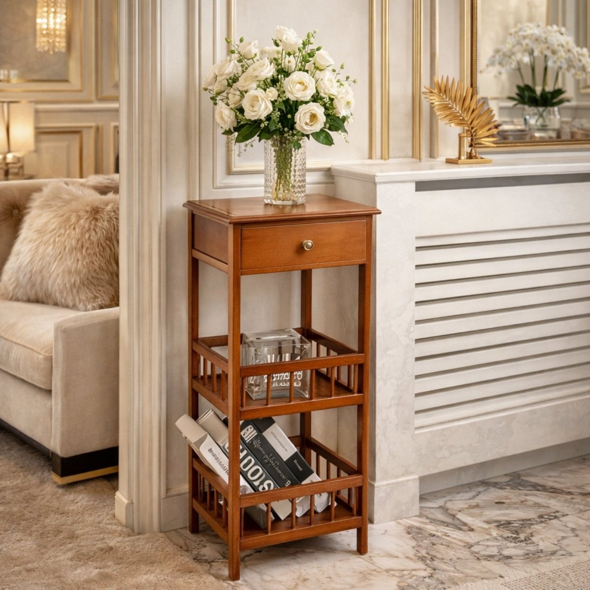 The narrow Kouvr table used as an entryway console, holding a vase of white roses and storing magazines on the lower shelf.
