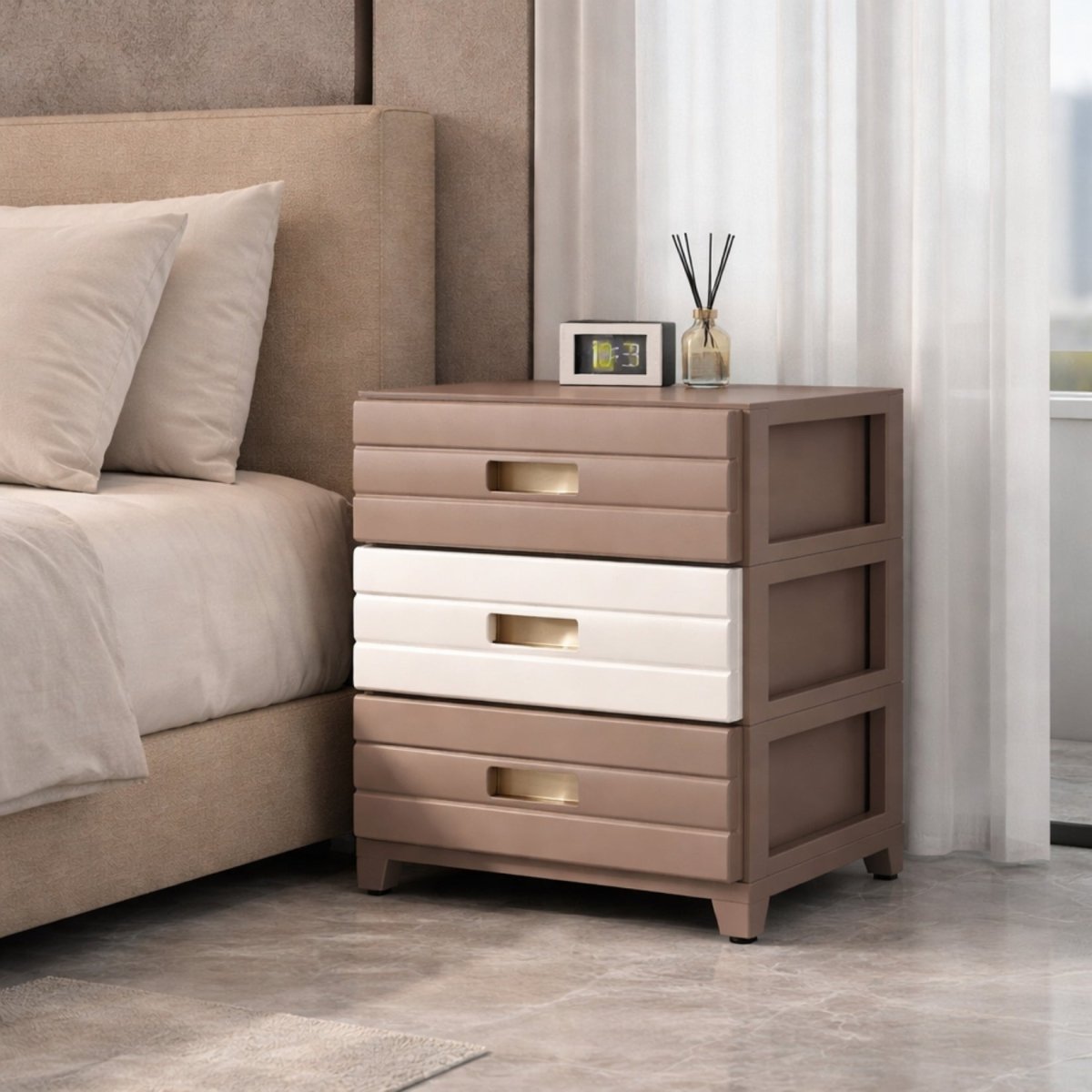 Elegant neutral taupe and cream three-tier drawer organizer used as a minimalist bedside table in a modern luxury bedroom.
