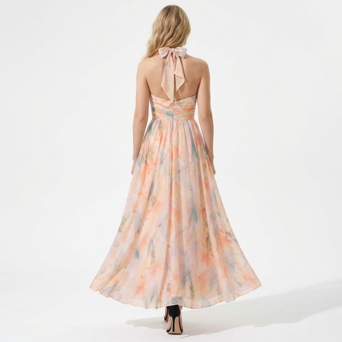 Back view of the floral halter maxi dress showing the elegant bow tie neck and open back.