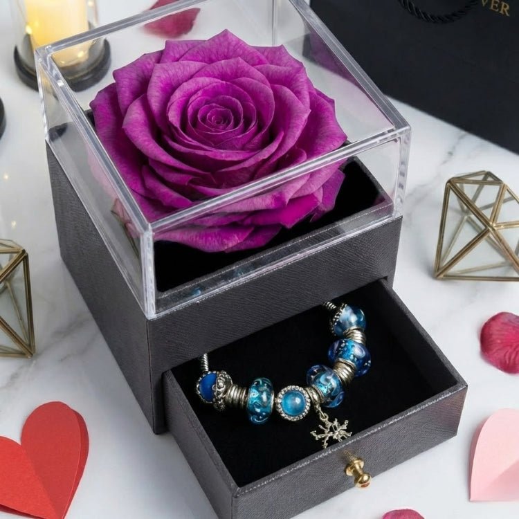 Detailed close-up of a violet purple preserved rose bloom inside a clear acrylic jewelry box, perfect for an anniversary or Valentine's gift.
