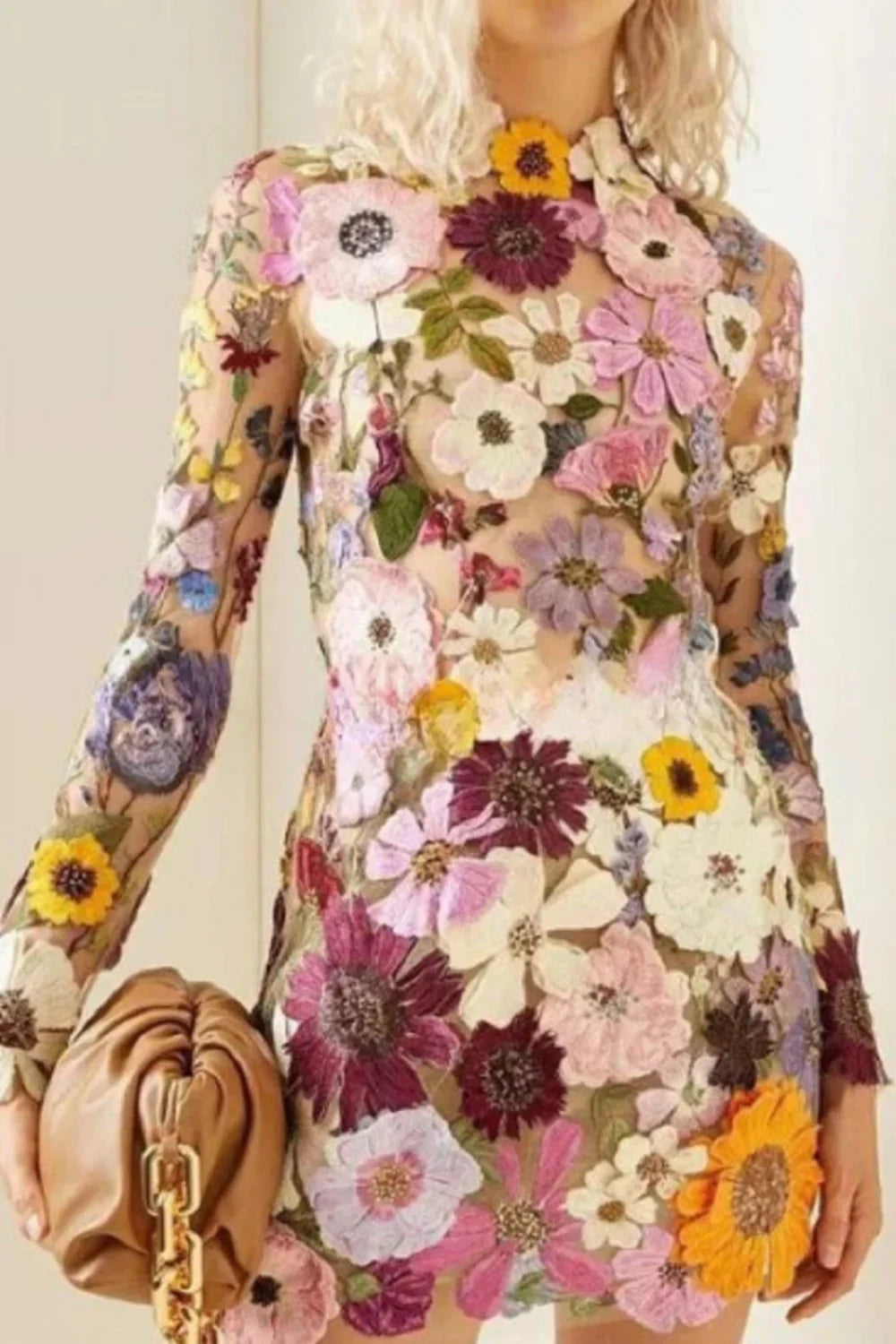 Model wearing Kouvr floral embroidered mini dress at a luxury event