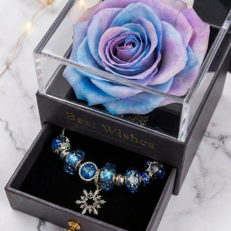 Angled shot of a mystical blue and purple preserved rose in a luxury gift box with "Best Wishes" gold text.