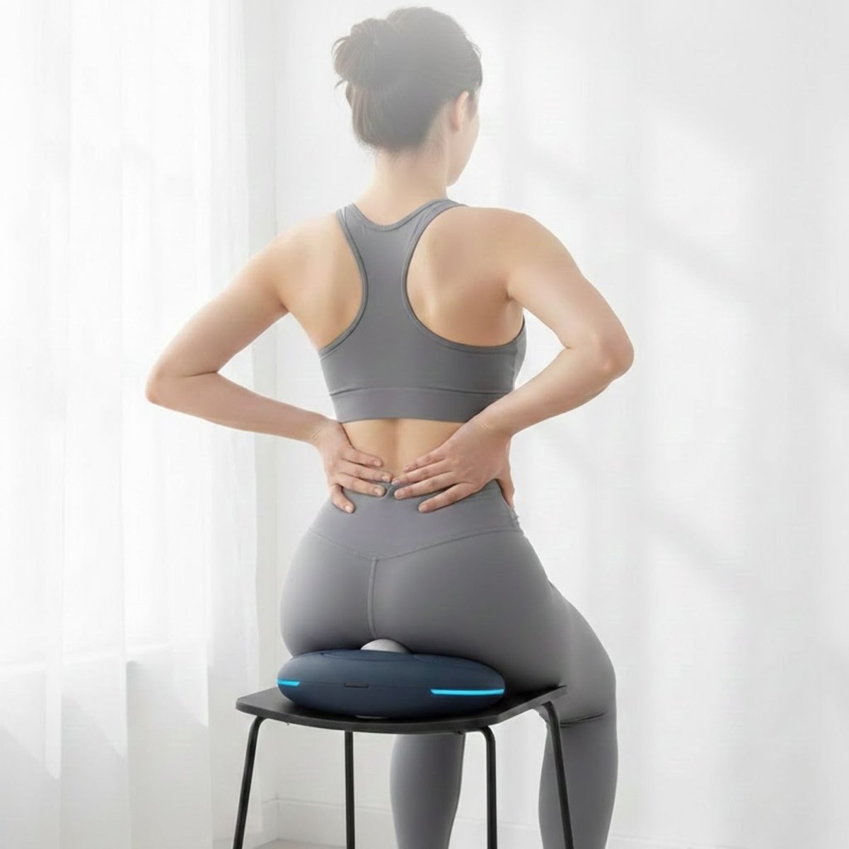 Ergonomic design of the Kouvr PC muscle trainer being used for daily core health and wellness.