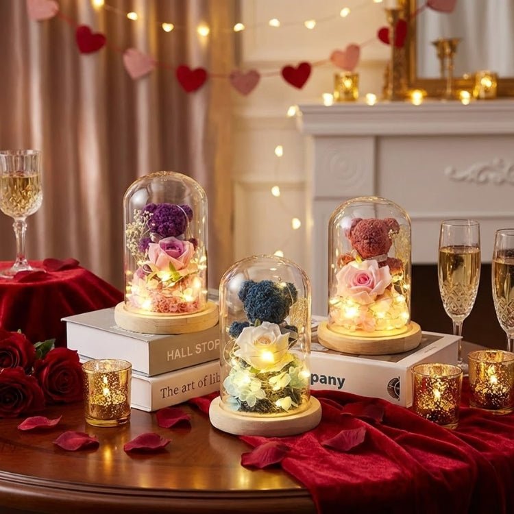 A luxury collection of multicolored preserved flower teddy bears in glass domes with LED lights on a romantic dinner table.