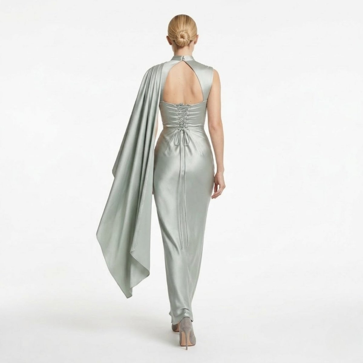 Back view of the Kouvr sage green satin wedding guest dress highlighting the adjustable corset lace-up back and keyhole cutout.
