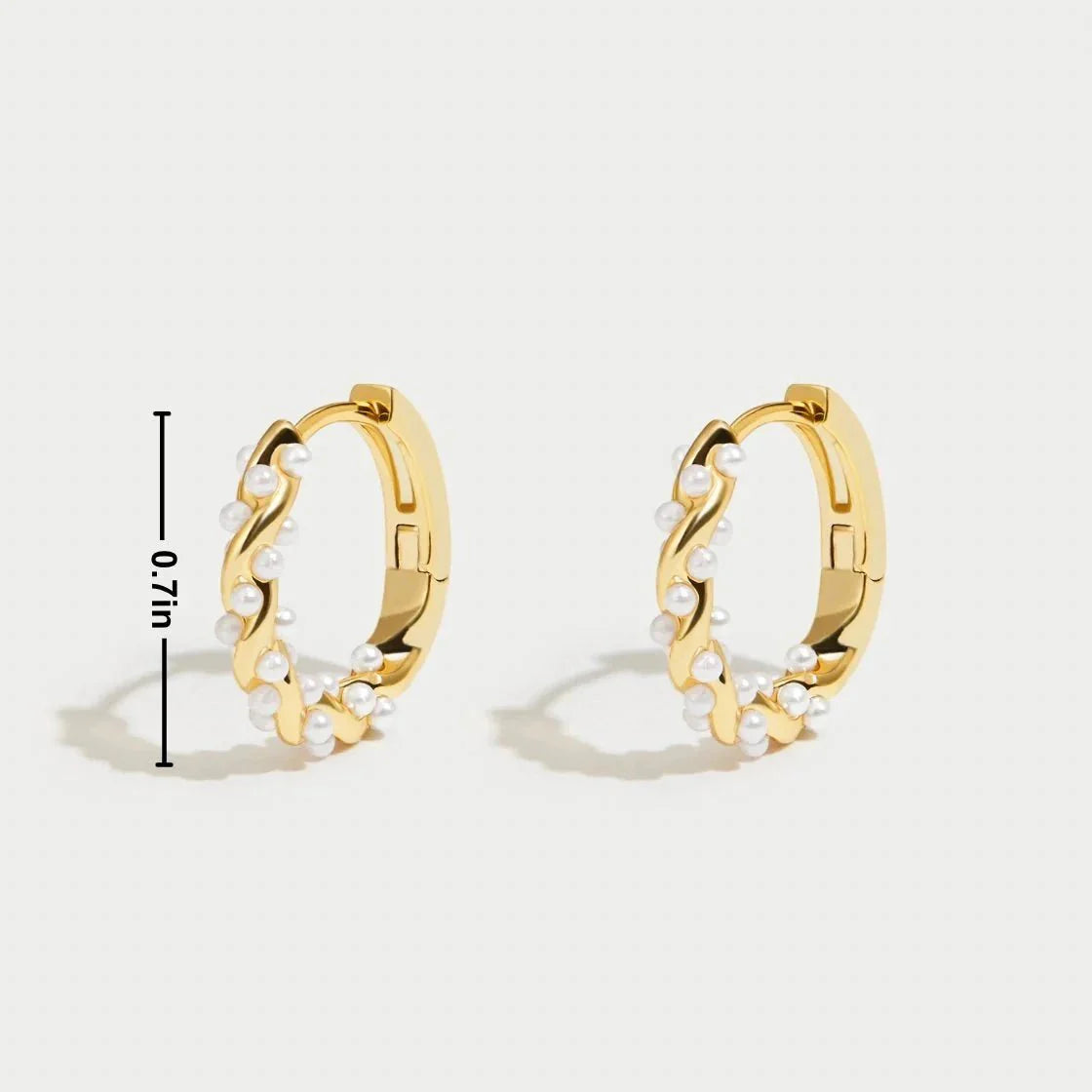 Model wearing Kouvr Kim small 18k gold pearl huggie hoop earrings