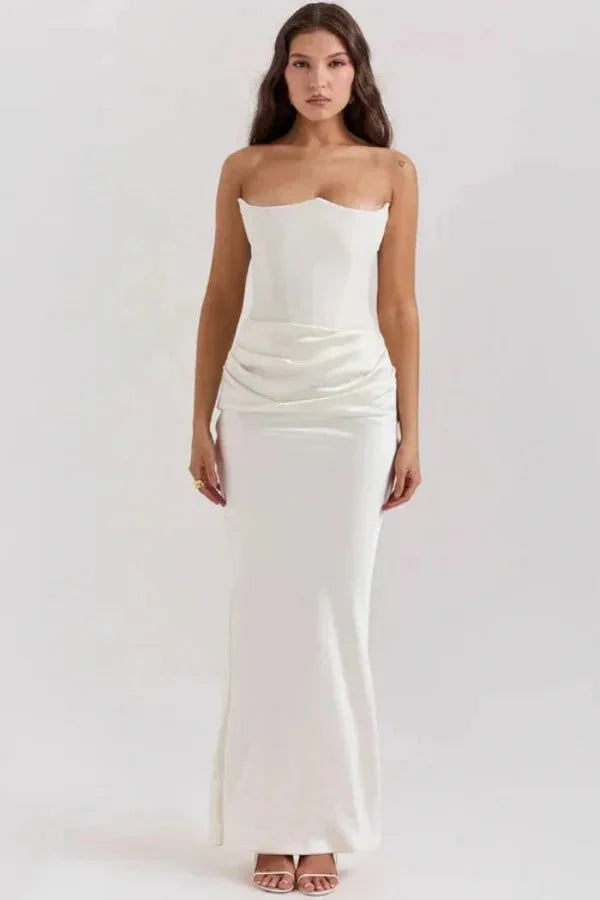 Model wearing the Zanayah white strapless corset maxi dress with ruched satin detail from Kouvr, shown from the front.