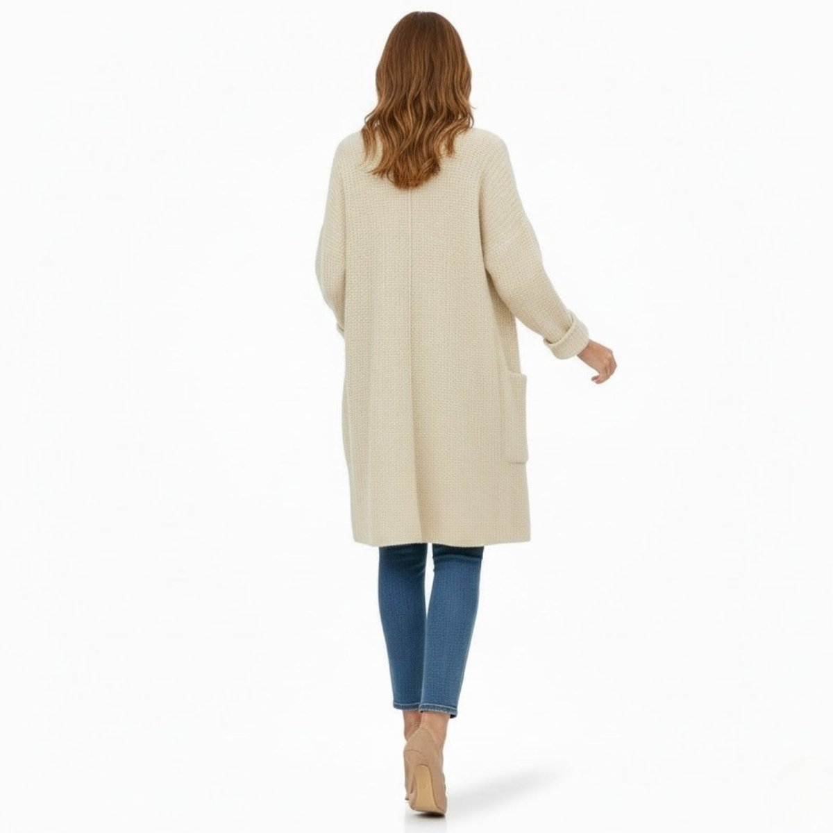  Back view of a model wearing the oversized ivory chunky knit cardigan, showing its length and relaxed fit.
