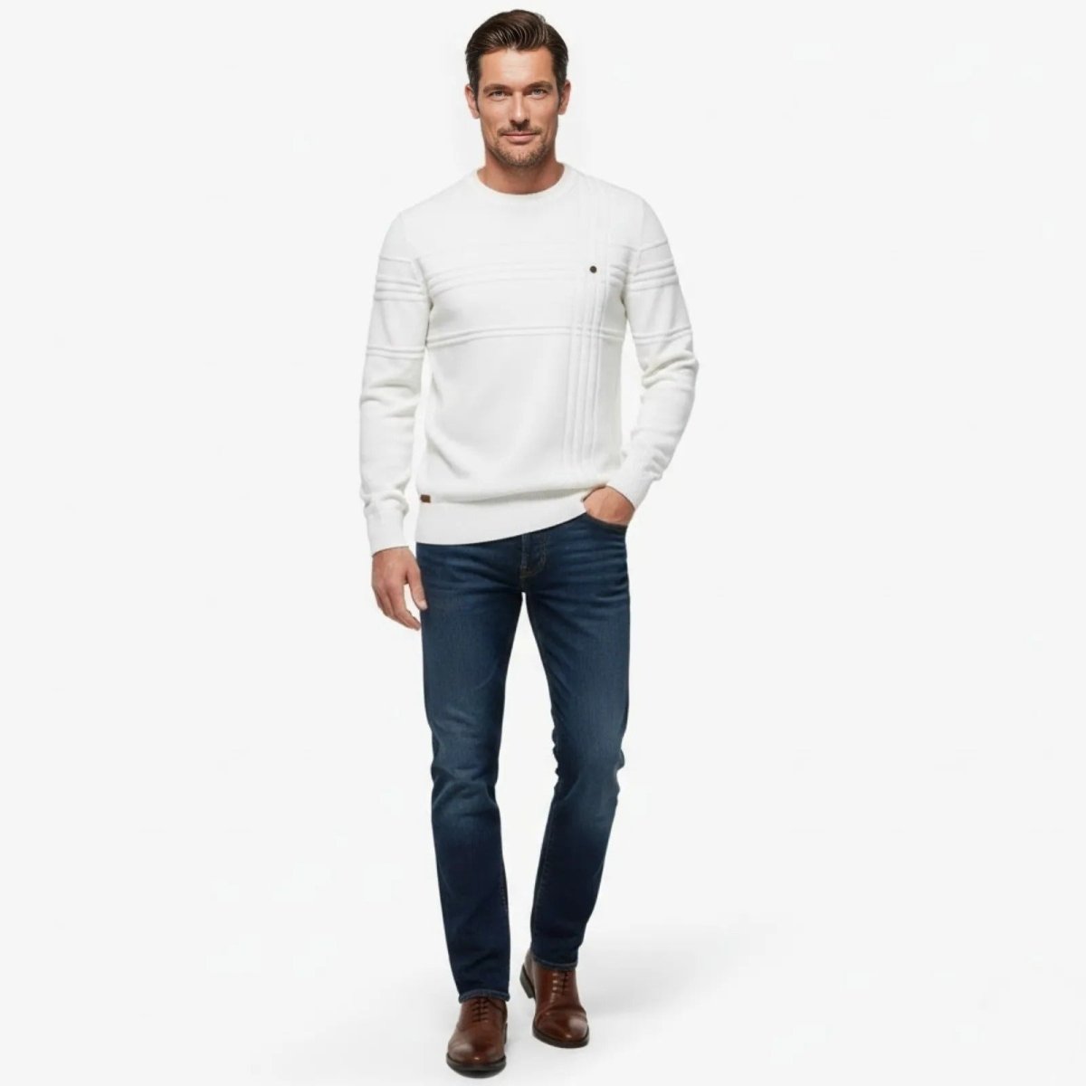Man wearing the Kouvr Ander Structured Knit Sweater in white with dark blue jeans, showing the full outfit from the front.