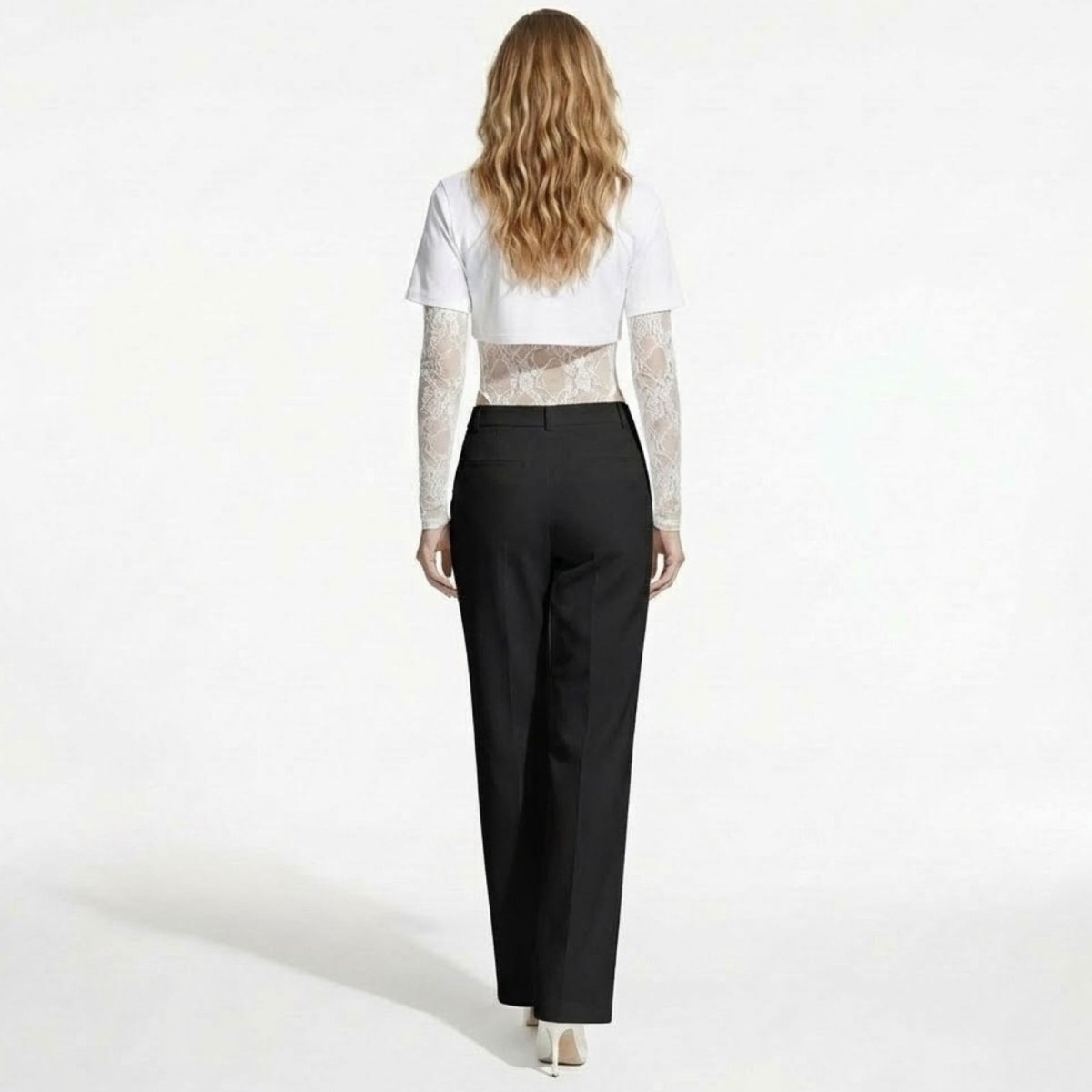 Back view of a model wearing the Angelique white layered bodysuit, highlighting the cropped t-shirt overlay and fitted shape.
