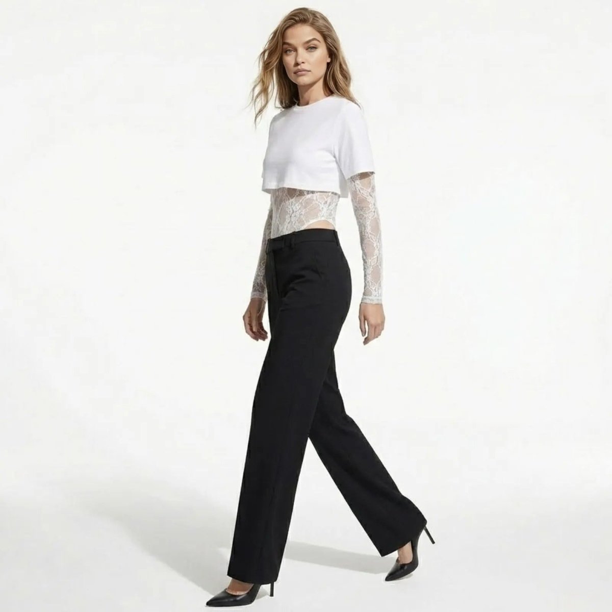 Model in a side profile walking pose wearing the Angelique white lace and jersey layered bodysuit, showing its silhouette and fit.
