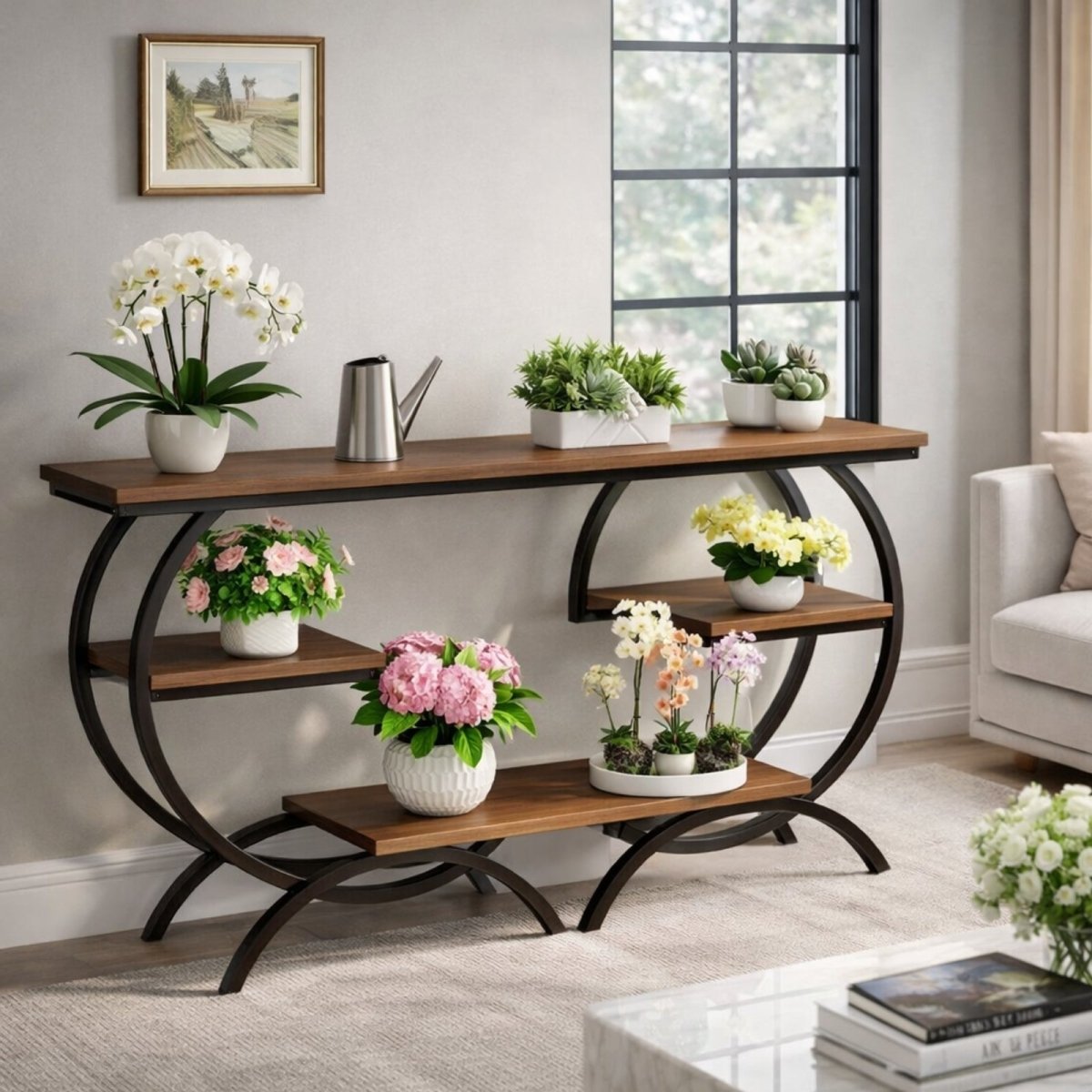 The larger console table from the Kouvr Arcadian collection, made of walnut and black metal, used as a multi-level plant stand in a bright room.
 