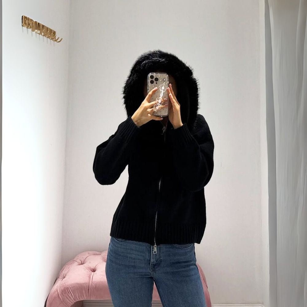 Woman wearing Kouvr black wool and cashmere blend hoodie with large fox fur trim hood