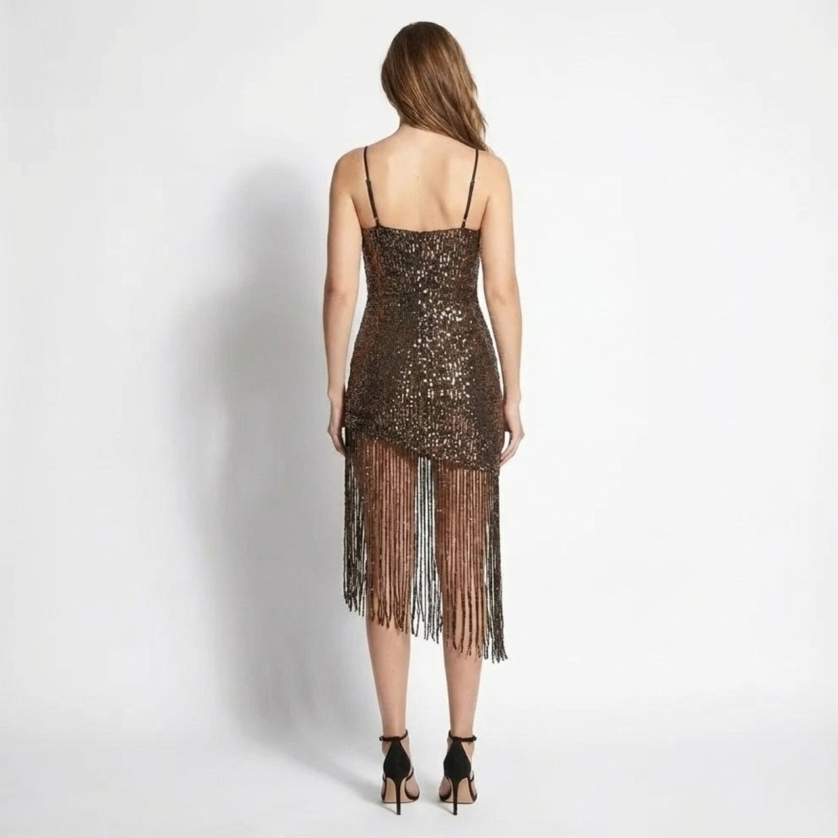 Back view of the Kouvr Fashion spaghetti strap sequin dress with asymmetric fringe, highlighting the silhouette.