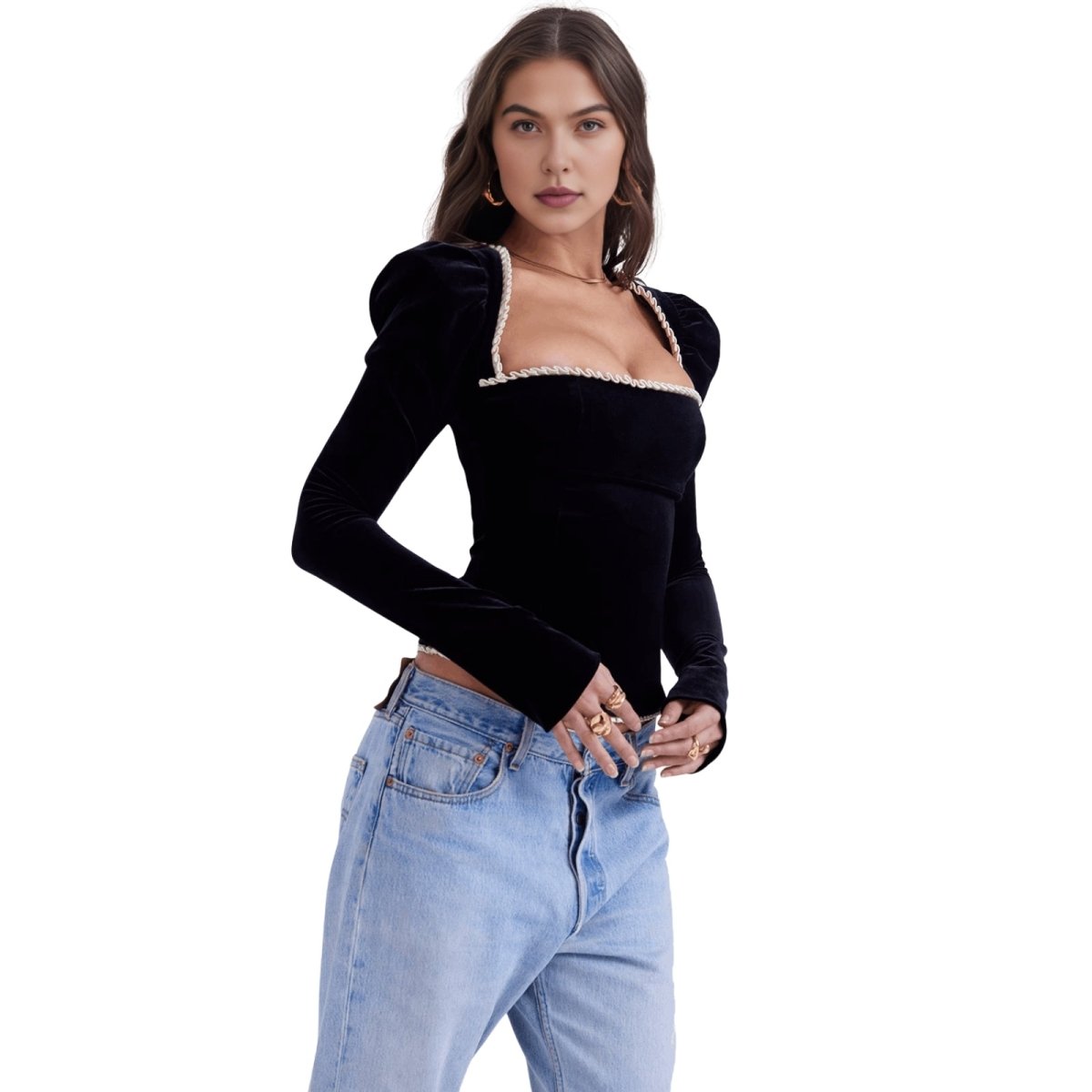 Kouvr woman wearing a black top with sheer neckline and light blue jeans on a white background