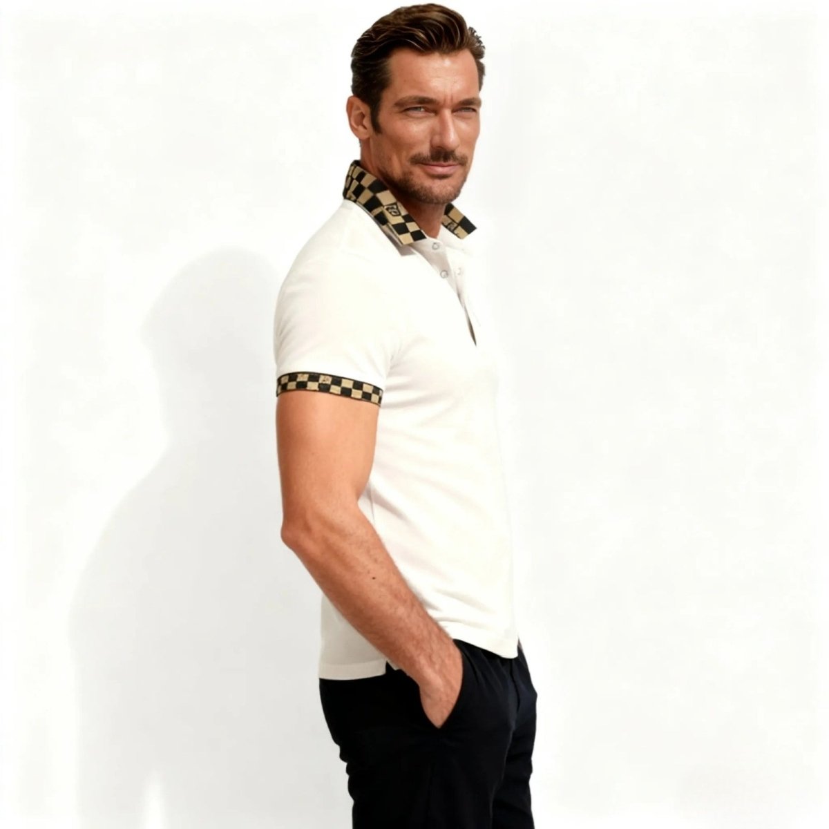 Side profile of a man in the Kouvr slim fit pink polo, showing the checkered pattern on the sleeve cuff and the tailored fit.