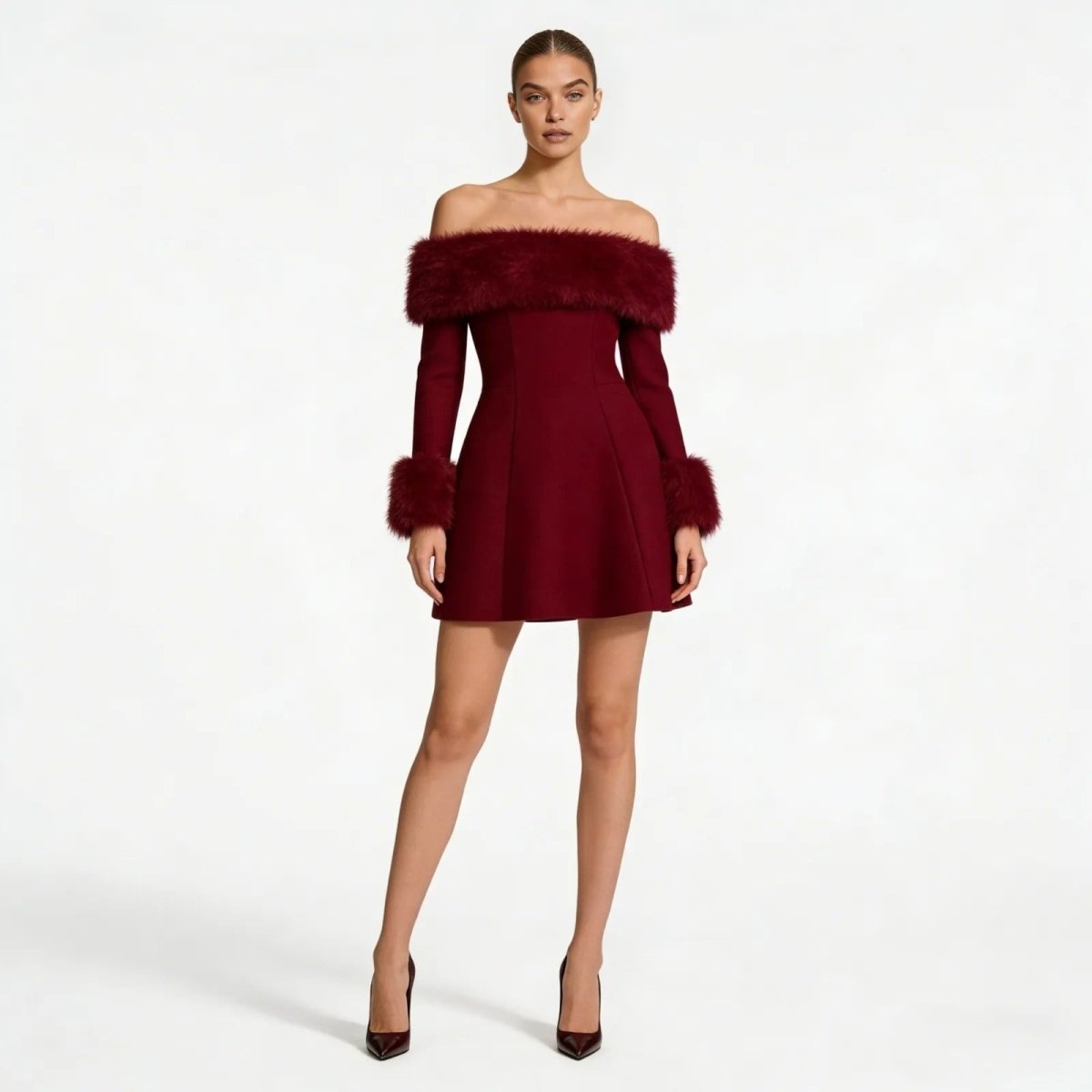 Model wearing the Kouvr burgundy off-the-shoulder mini dress with long sleeves and faux fur trim, front view.