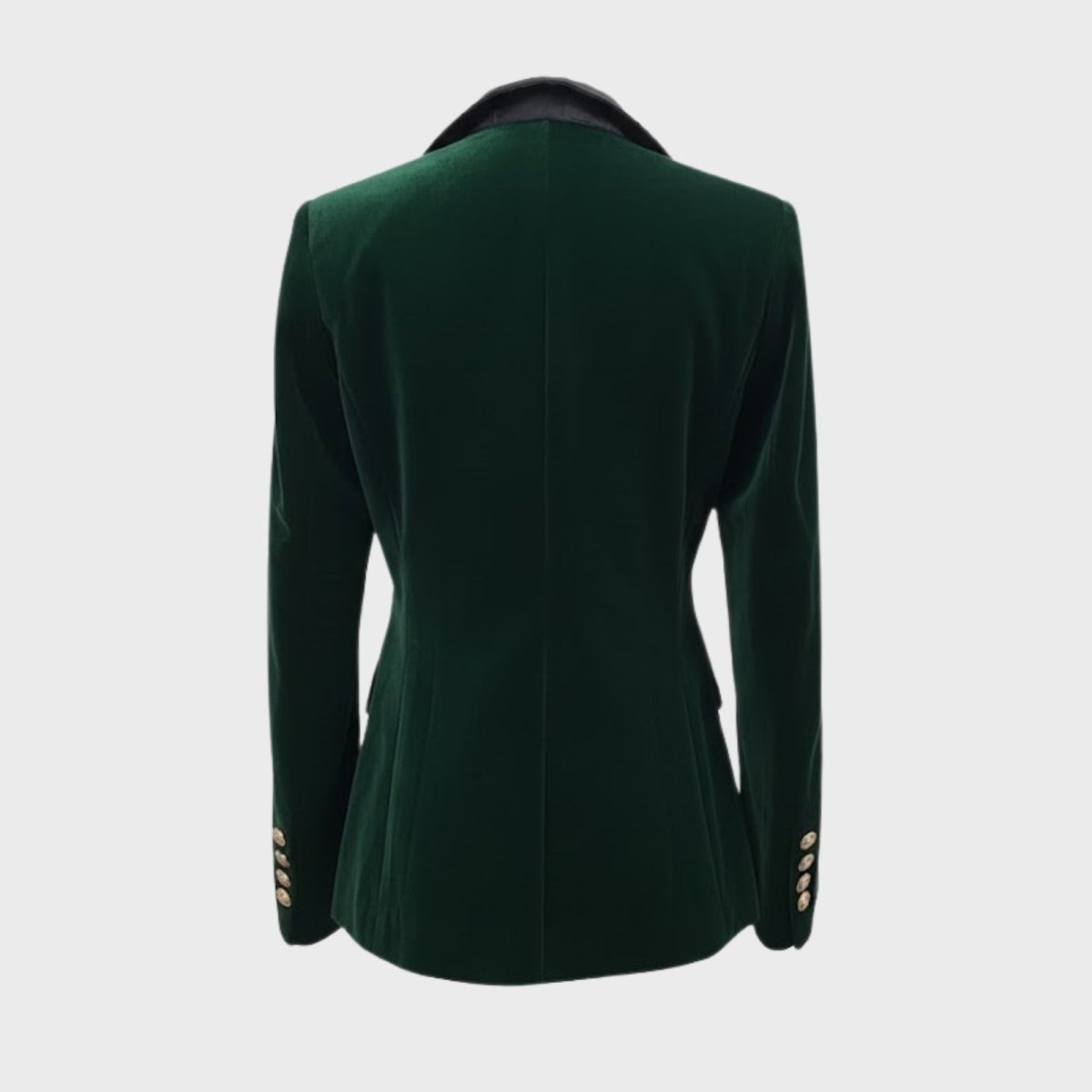 Detail shot of the back of the Kouvr dark green blazer, highlighting the structured tailoring and gold cuff buttons.
