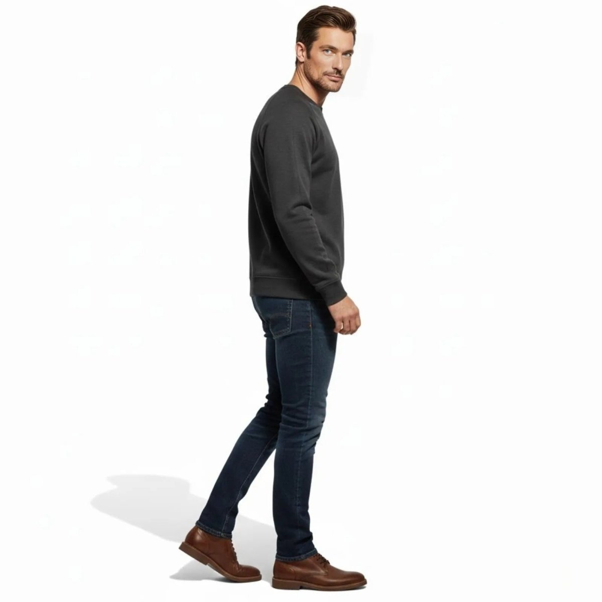 Side profile of a man in the Kouvr Deacon Crewneck Sweatshirt showing the fit and raglan sleeve detail.