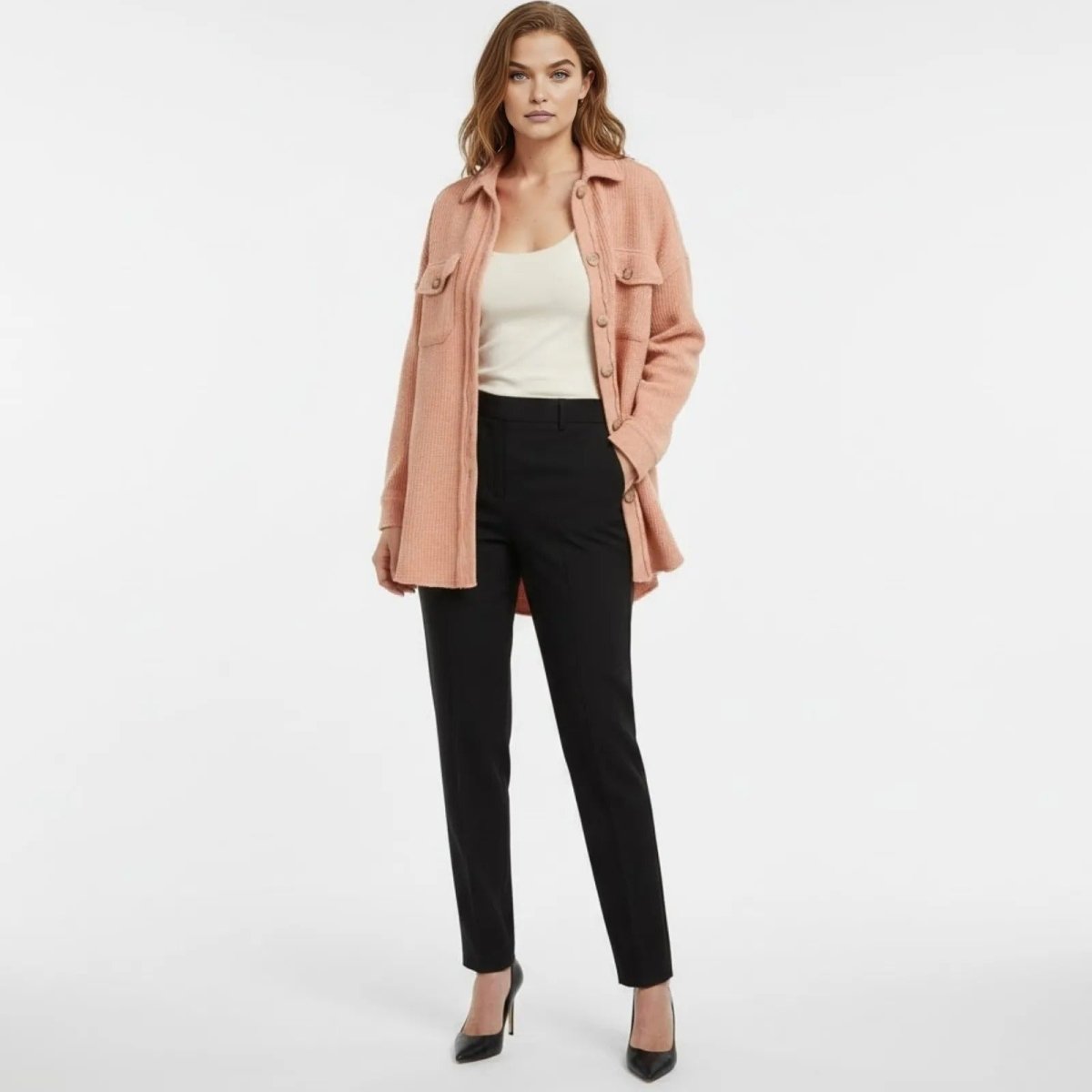 Model wearing the Kouvr Fashion Donna oversized waffle knit shacket in apricot, styled open over a white camisole and black trousers.