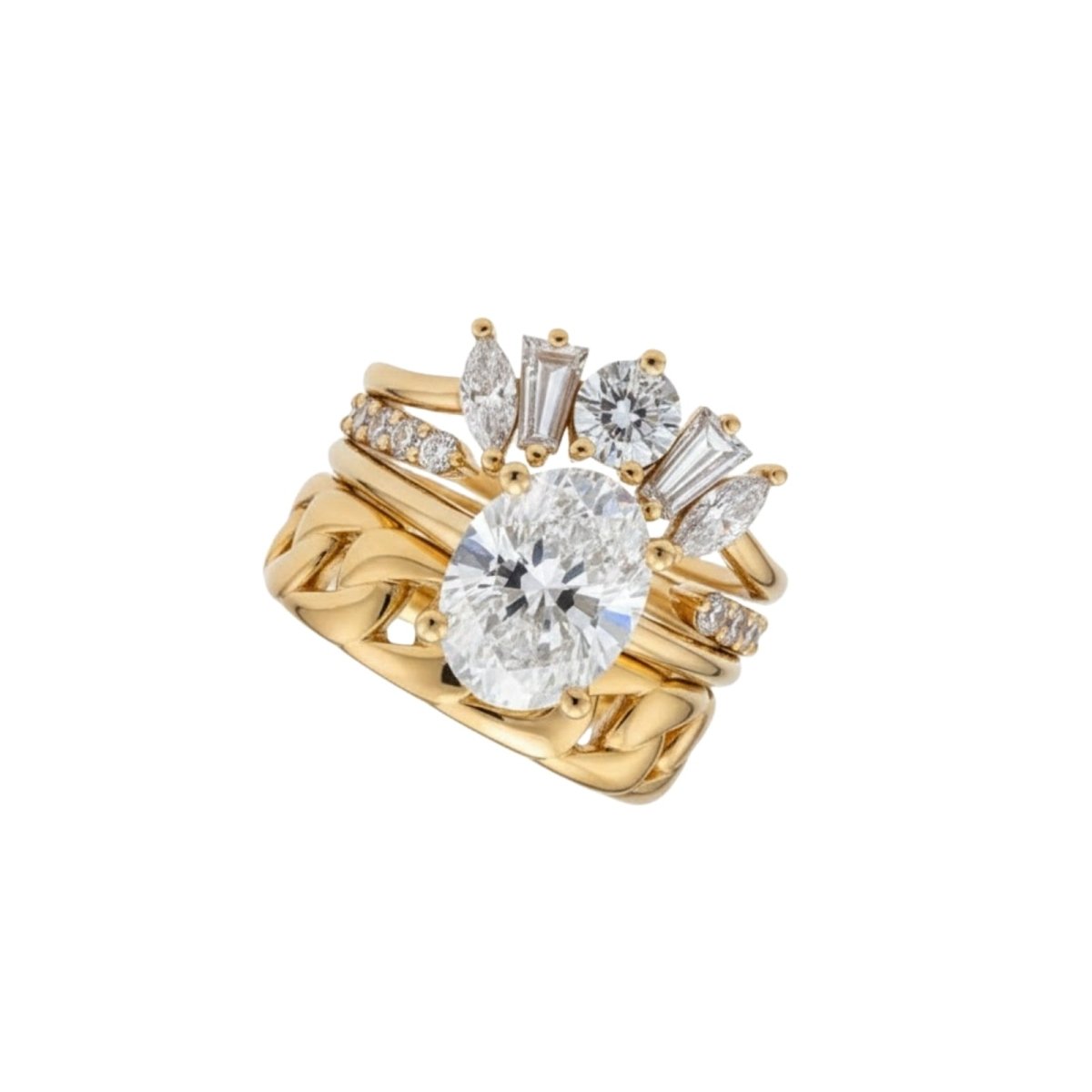 Angled studio product shot of the complete Kouvr Emersyn handcrafted diamond and 18K gold wedding ring suite against a white background.