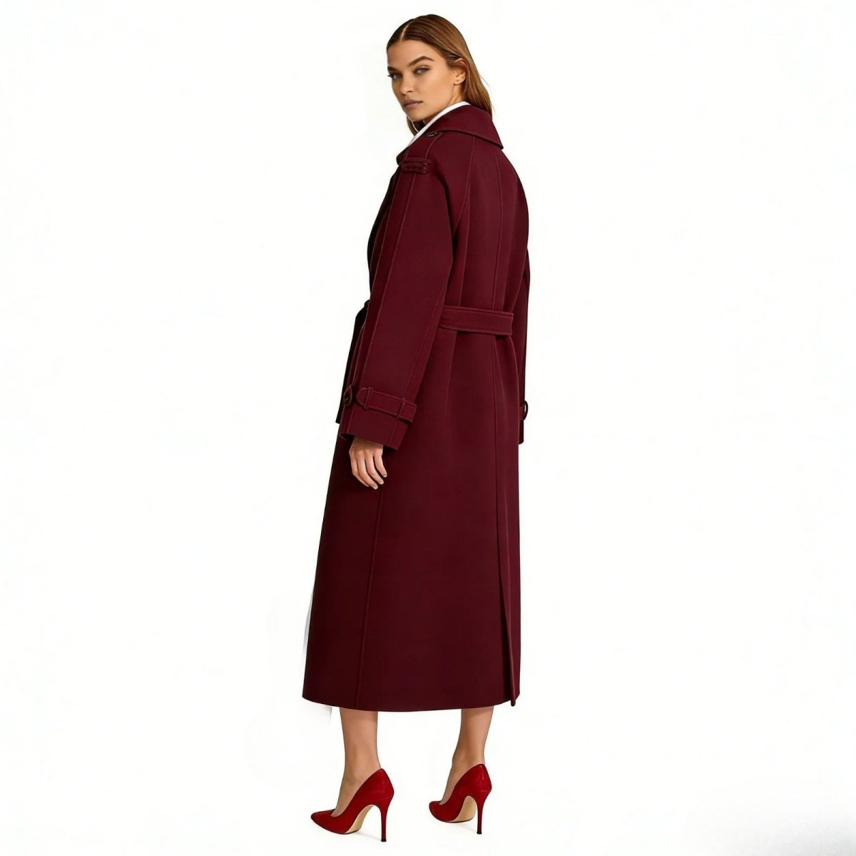 Back view of a model wearing the Kouvr Fashion Esther trench coat in burgundy, highlighting the storm flap detail and clean tailoring.
