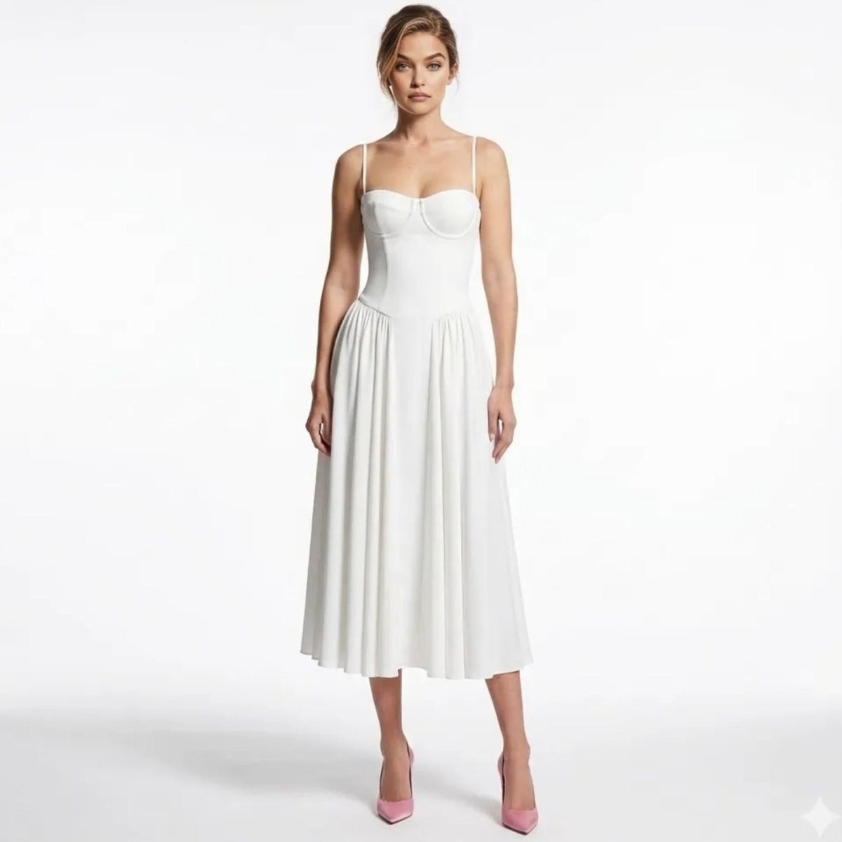 Model wearing the Evdokia white corset bustier midi dress by Kouvr Fashion, front view, styled with pink heels. 