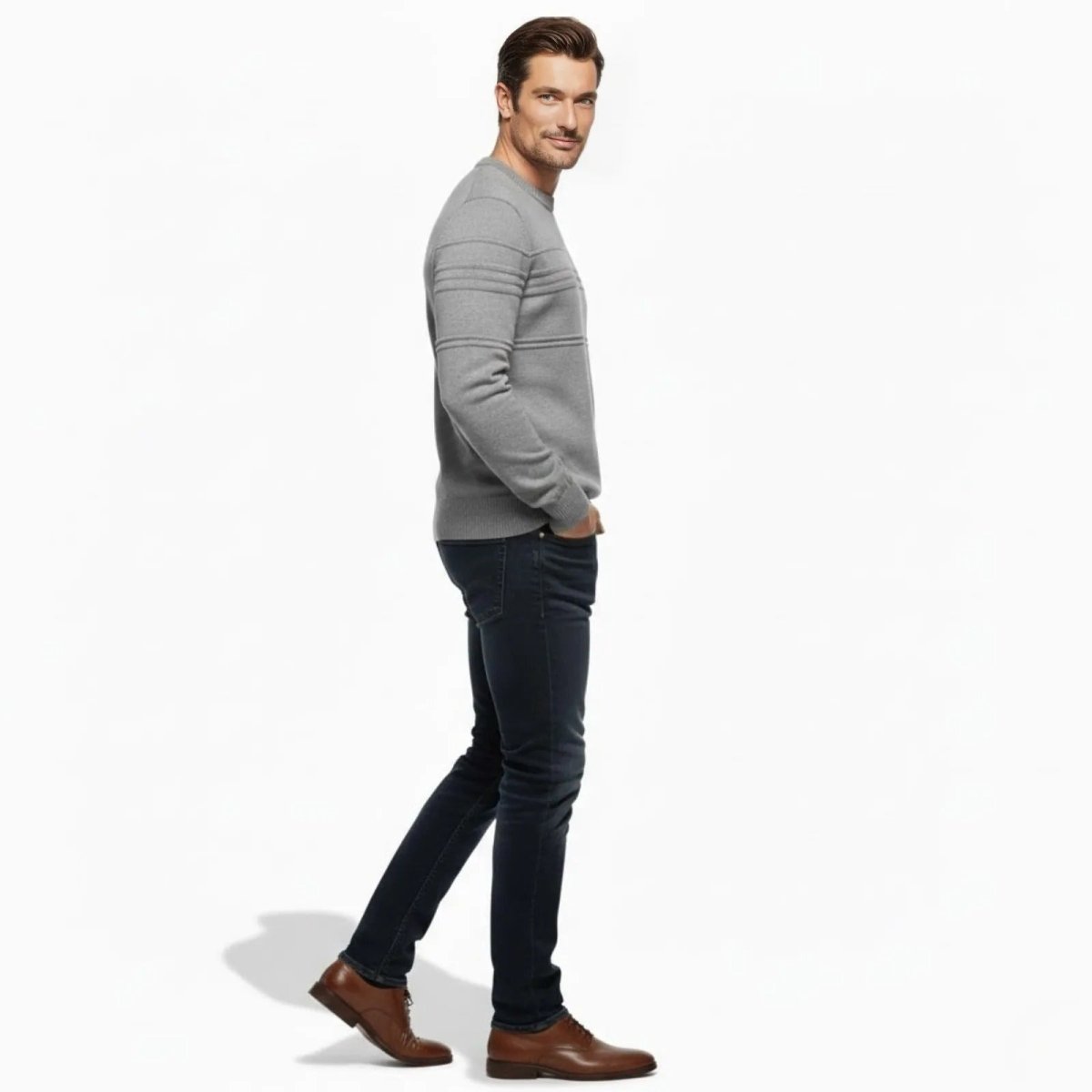 Side profile of a man wearing the Kouvr Fashion Ander heather grey sweater showing the structured panel detailing on the sleeve.