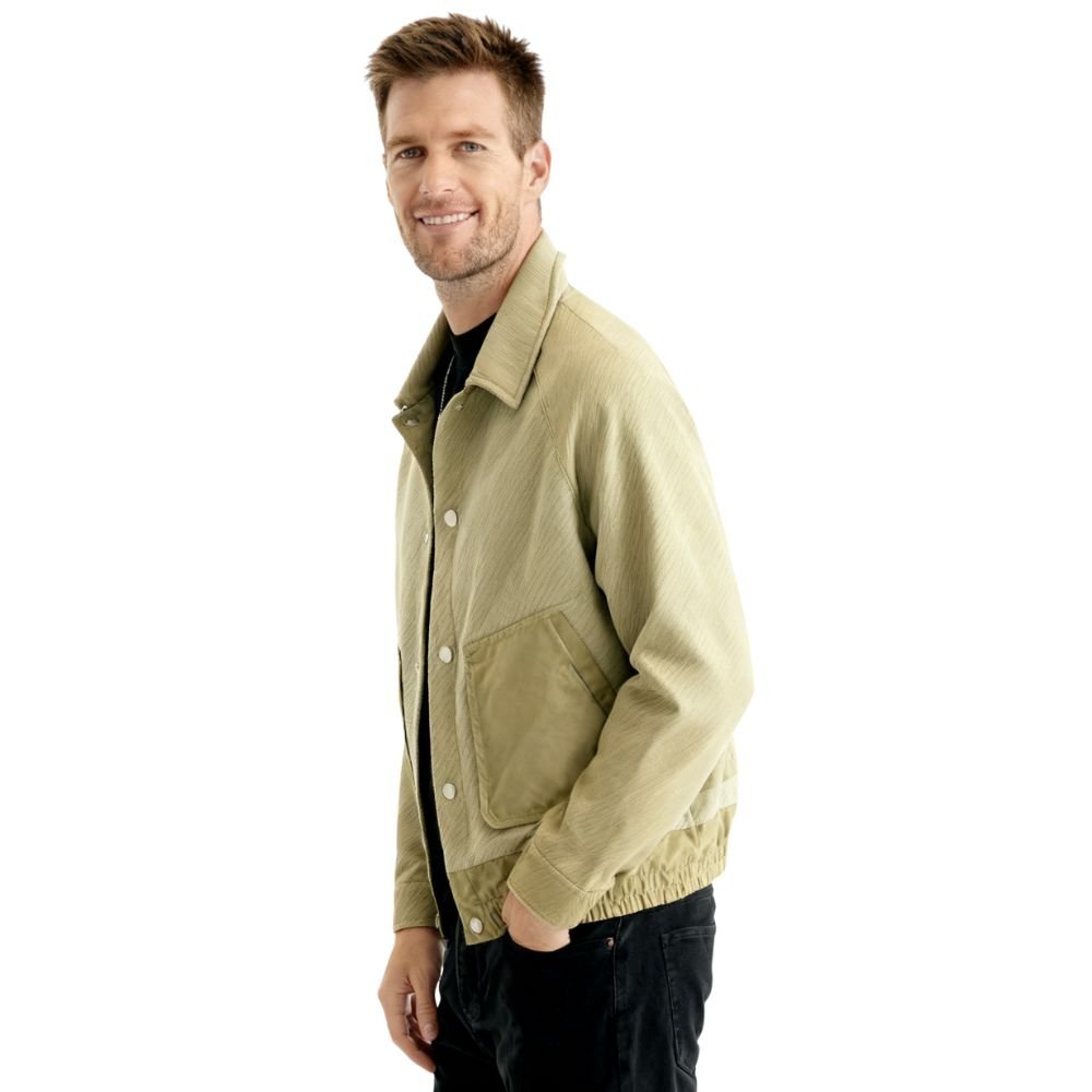Man wearing a khaki kouvr jacket on a white background