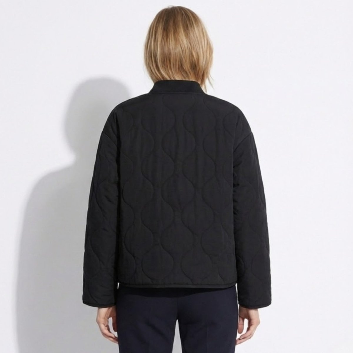 Back view of the Kouvr Fashion women's black onion quilt jacket showing its relaxed silhouette.
