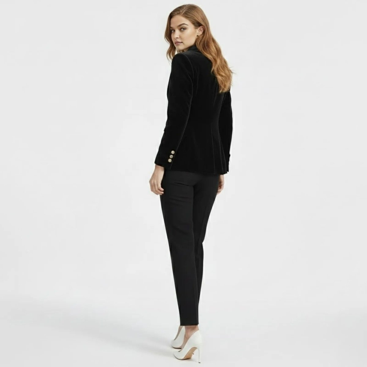 Back view of the Kouvr Fashion women's fitted black velvet tuxedo jacket, highlighting the structured shoulders and silhouette.
