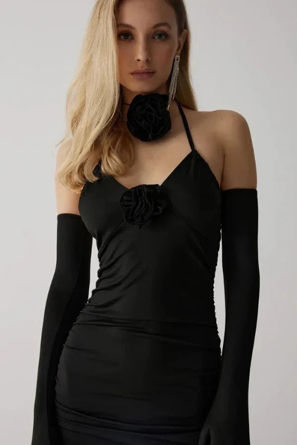 Model wearing Kouvr Fashion Chanti Bloom black ruched mini dress with matching opera gloves and rosette choker
