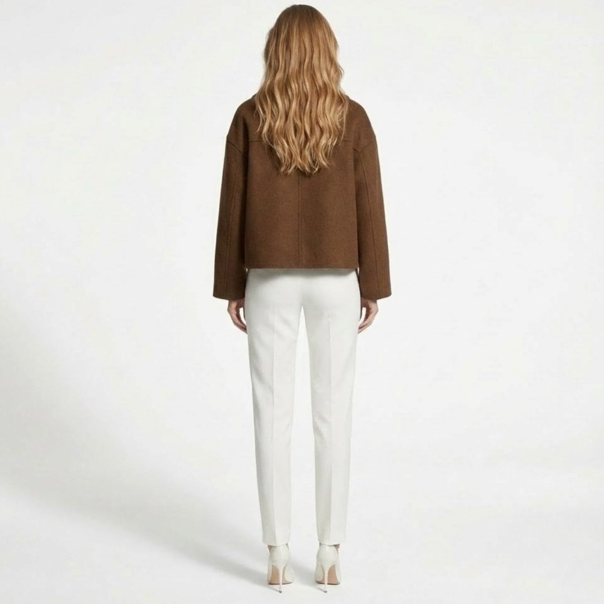 Back view of the Kouvr Fashion cropped wool jacket in cognac brown, highlighting the central seam and structured fit.
