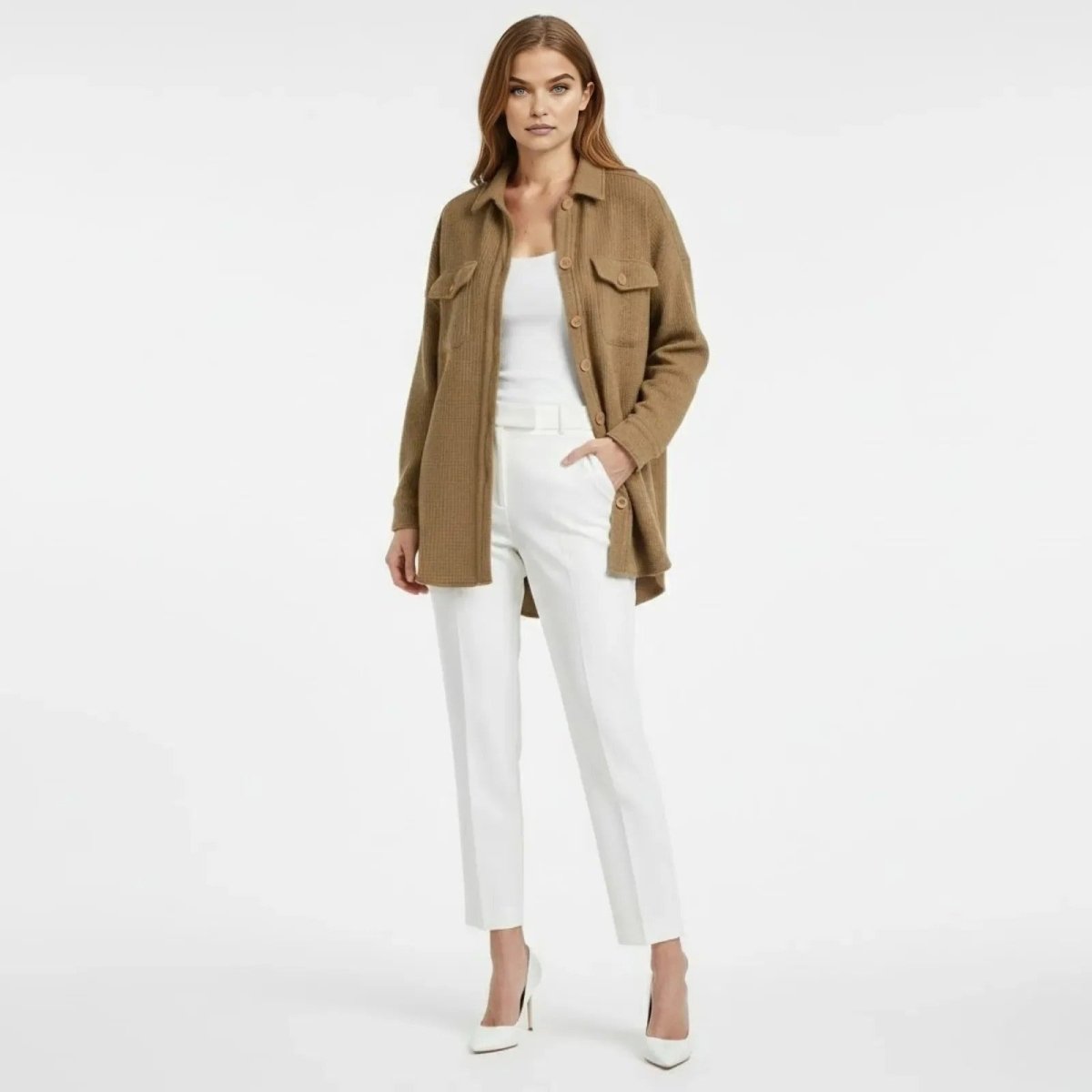 Model wearing the oversized Donna Waffle Knit Shacket in khaki by Kouvr Fashion, styled open with a white top and white trousers.