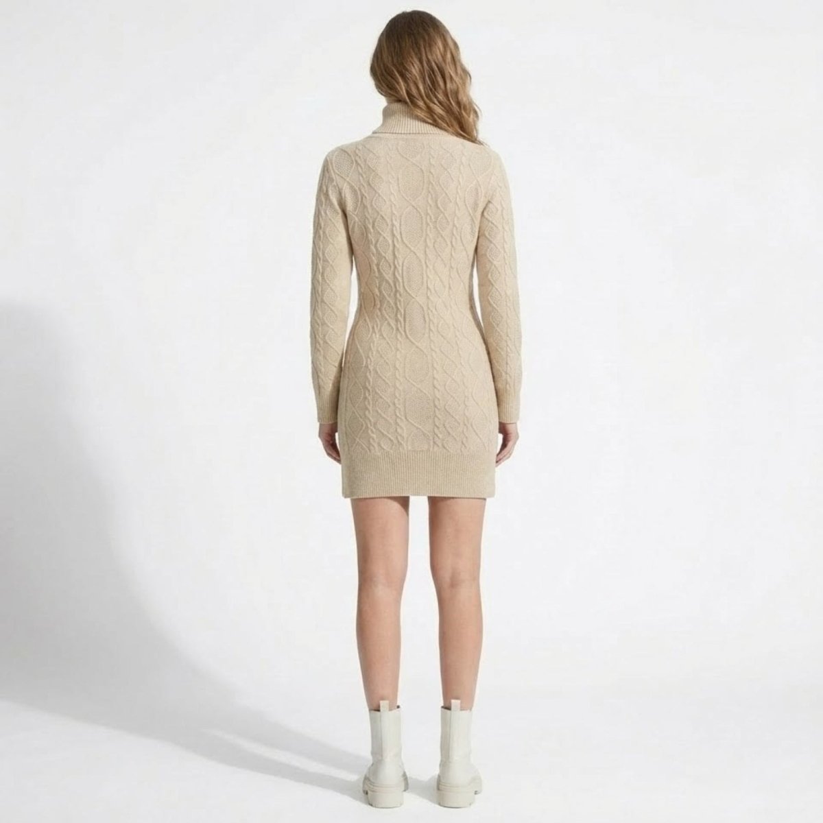 Back view of the Kouvr Fashion beige cable knit mini dress, showcasing the continuous Aran knit pattern down the back.