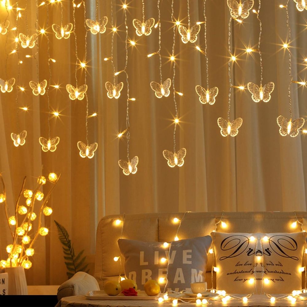 Kouvr Fashion's Fairy Flutter Lights creating a magical, romantic glow over a headboard in a luxury bedroom