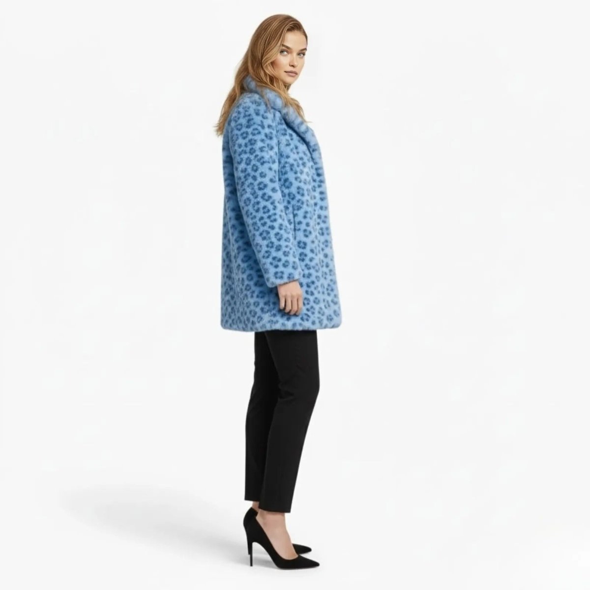 Side profile of a model wearing the blue leopard print faux fur Jovi coat by Kouvr Fashion, showing its mid-thigh length and relaxed silhouette.
